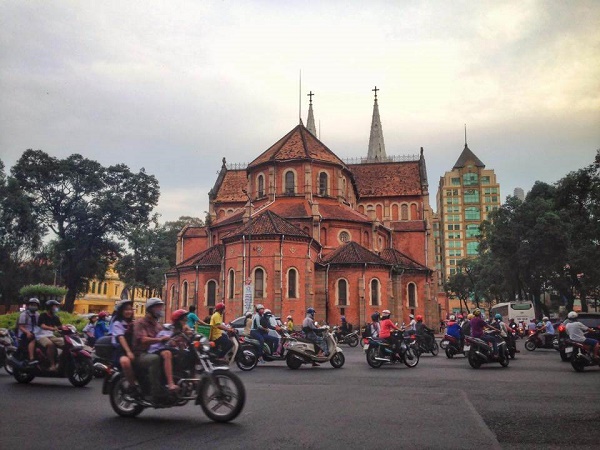 Notre Dame Cathedral and scooter traffic in Saigon, Vietnam