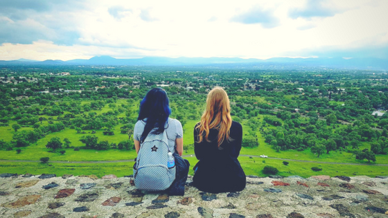 Two budget backpackers staring out into the distance at Teotihuacan, Mexico